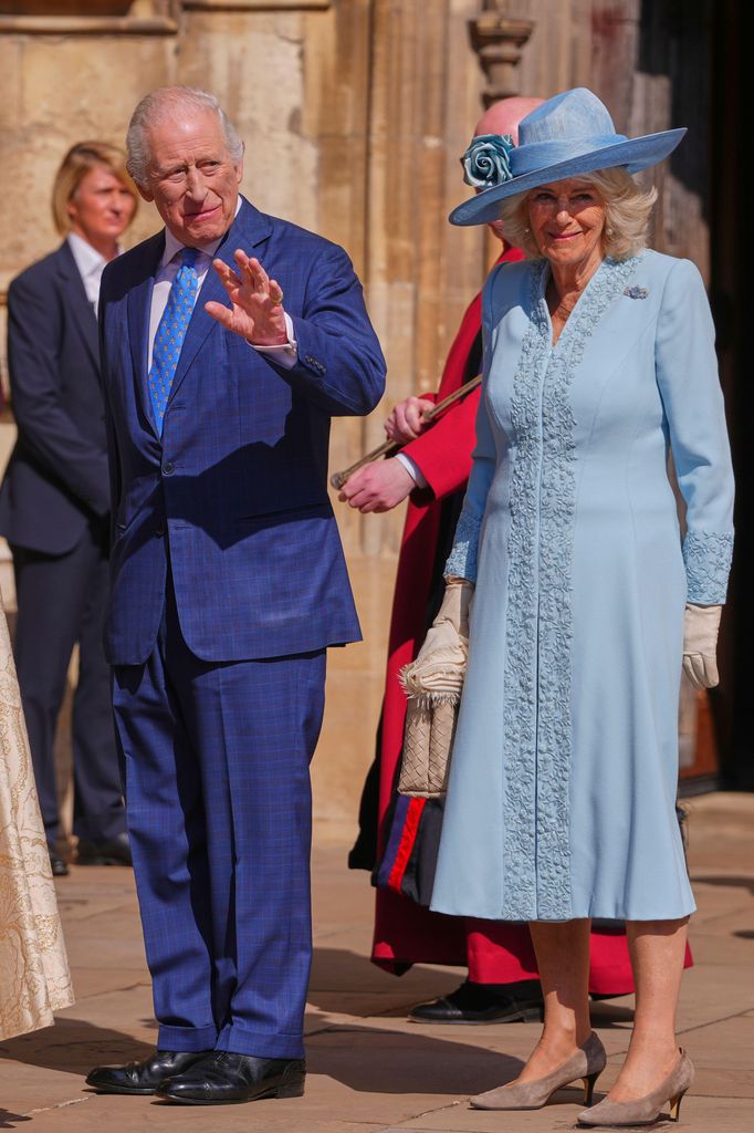 King Charles III and Queen Camilla wave at the crowd as they arrive 
