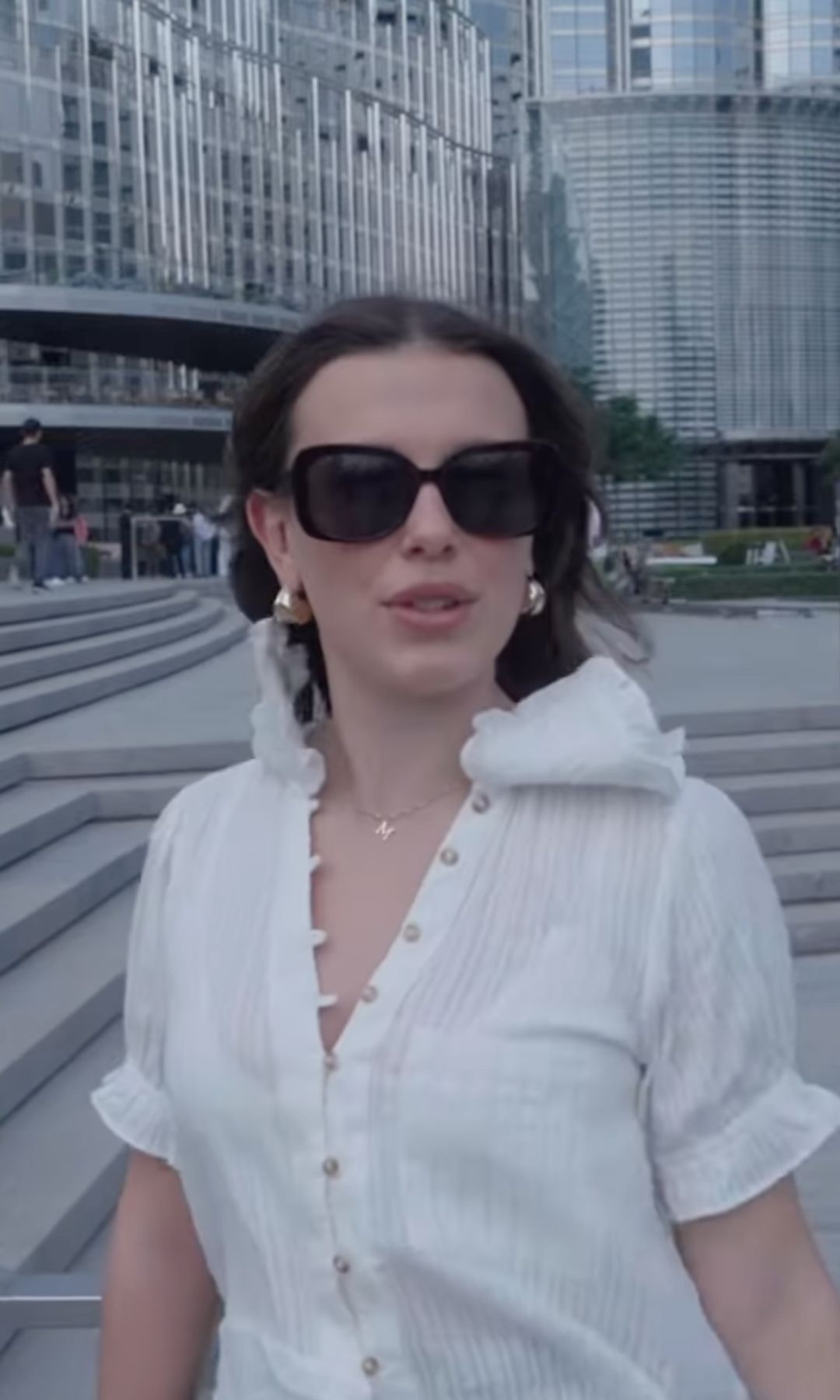 Millie Bobby Brown's showcases her gold statement earrings and simple gold necklace