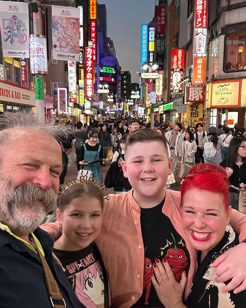 The Strawbridges take a family selfie with Tokyo street in the background