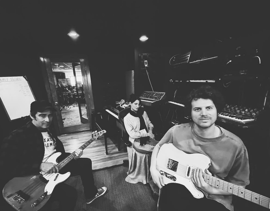 Photo shared on Instagram by Audrey Mcgraw of black-and-white photo, featuring her in the music studio, sitting next to musicians Jeff Hill and Kyle Emerson