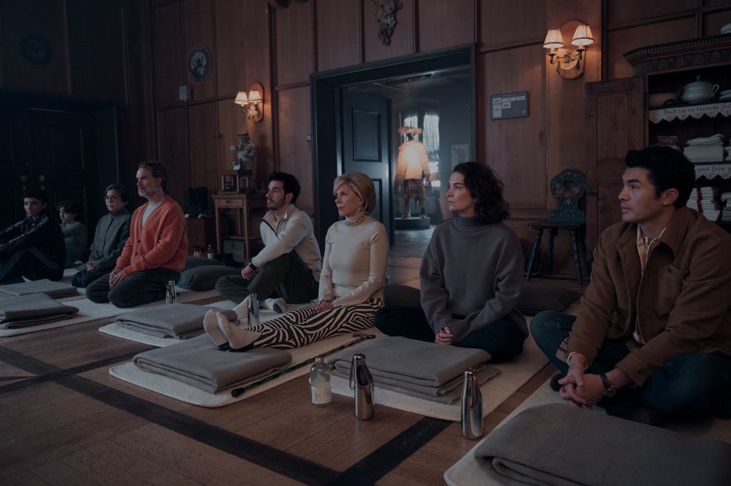 group of people sitting on yoga mats