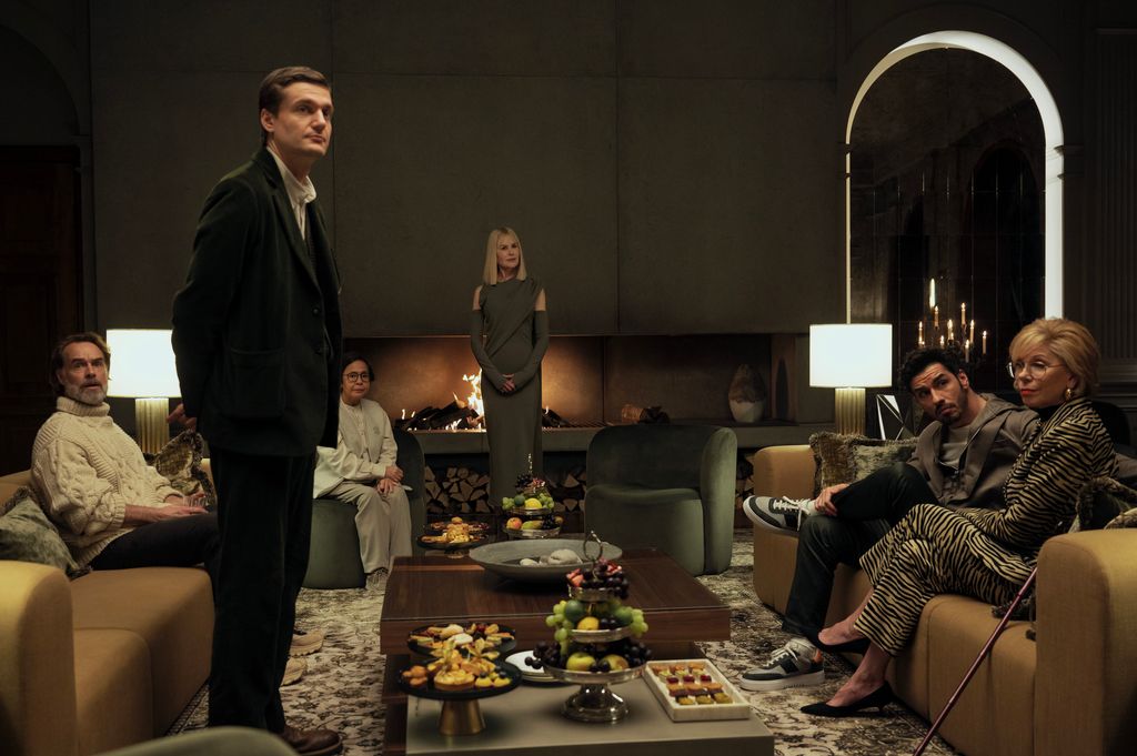 group of people sitting in living room with fireplace
