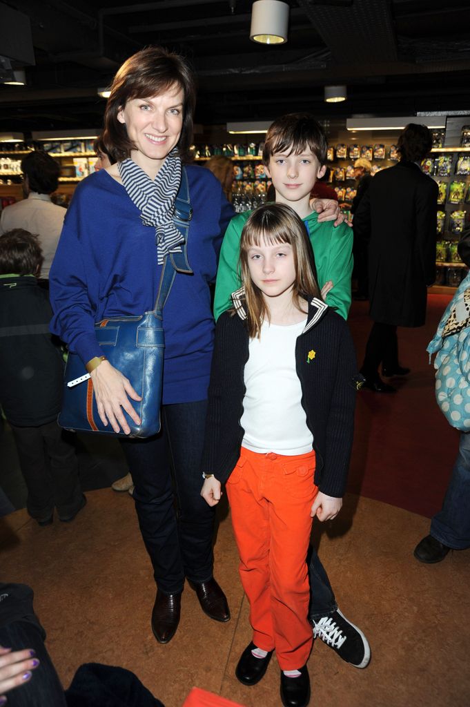 mother with son and daughter in toy shop