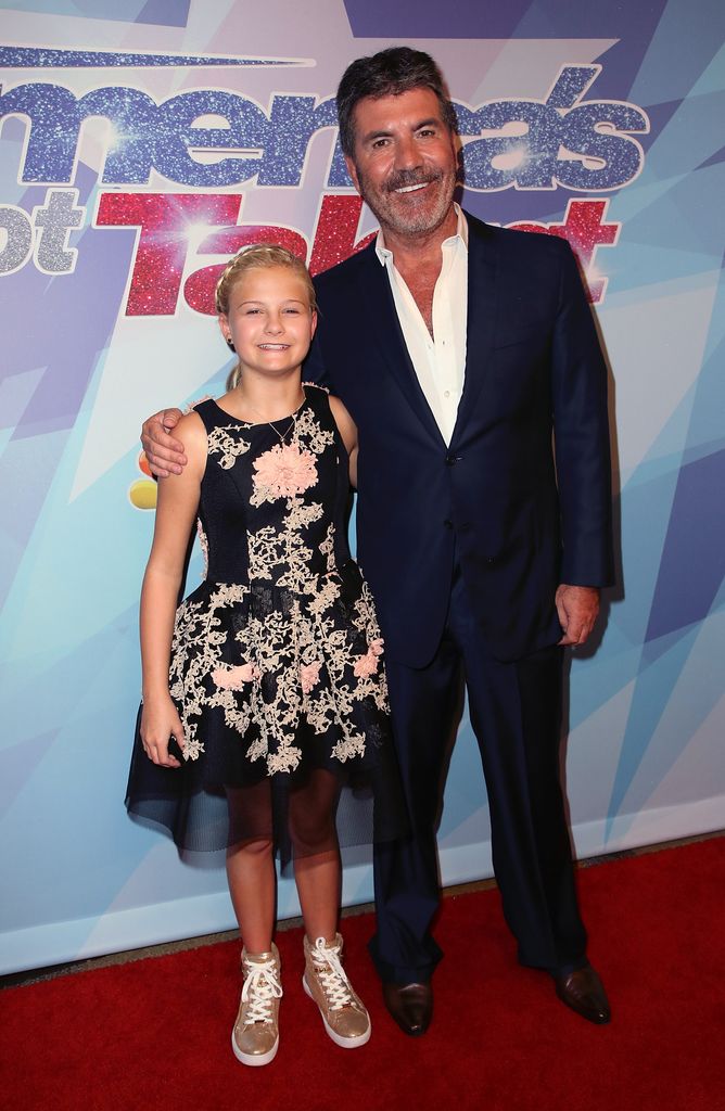 Season 12 winner ventriloquist Darci Lynne Farmer (L) and judge/executive producer Simon Cowell attend NBC's "America's Got Talent" season 12 finale at Dolby Theatre on September 20, 2017 in Hollywood, California