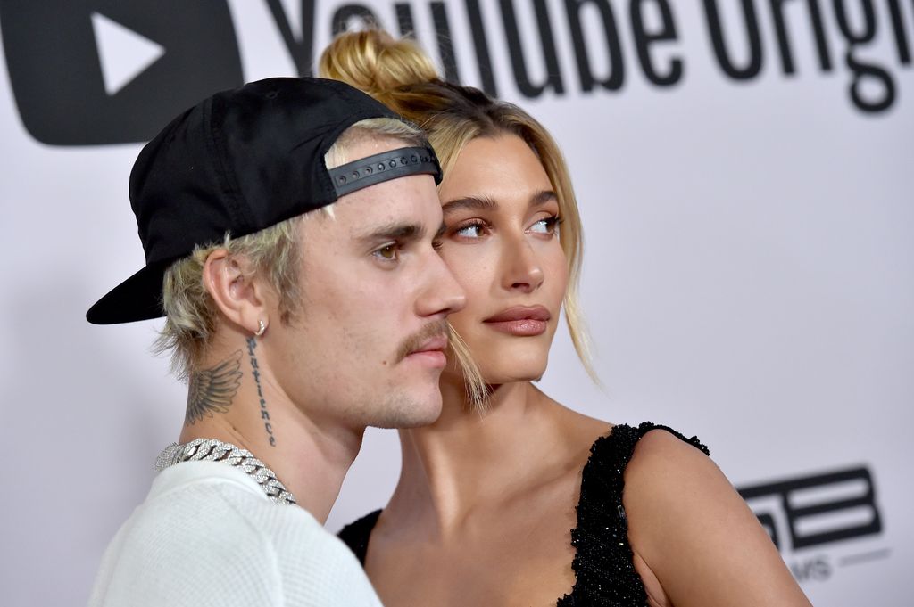 Hailey Bieber and Justin Bieber stand head to head on the red carpet of YouTube event while posing for photographs