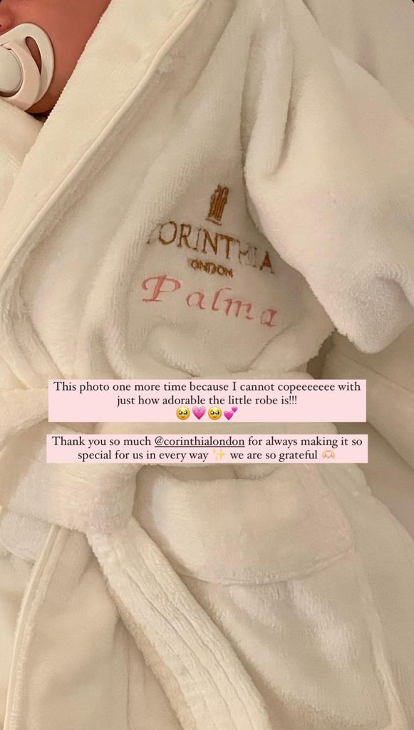 A baby girl wrapped up in a white dressing gown