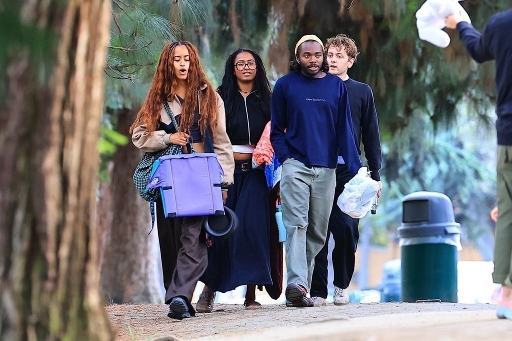 Malia and Sasha Obama walking in park with friends