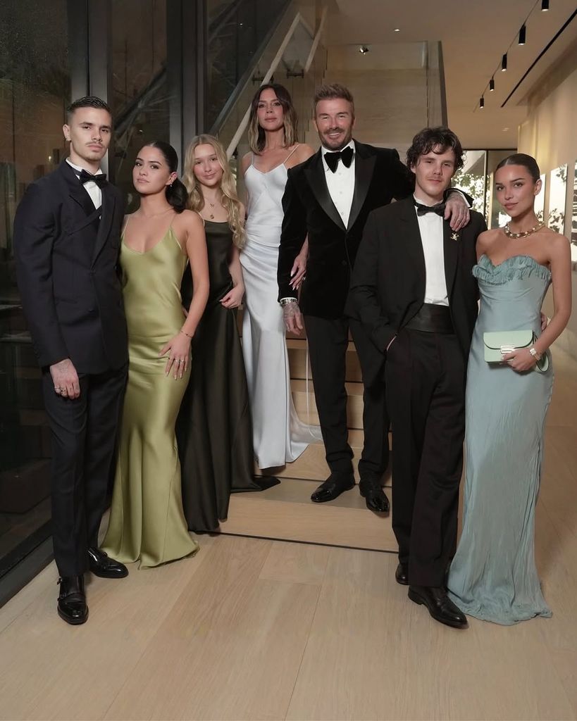 Romeo Beckham, Kim Turnbull, Harper Beckham, Victoria Beckham, David Beckham, Cruz Beckham and Jackie Apostel standing in the hallway in front of stairs at their Miami home