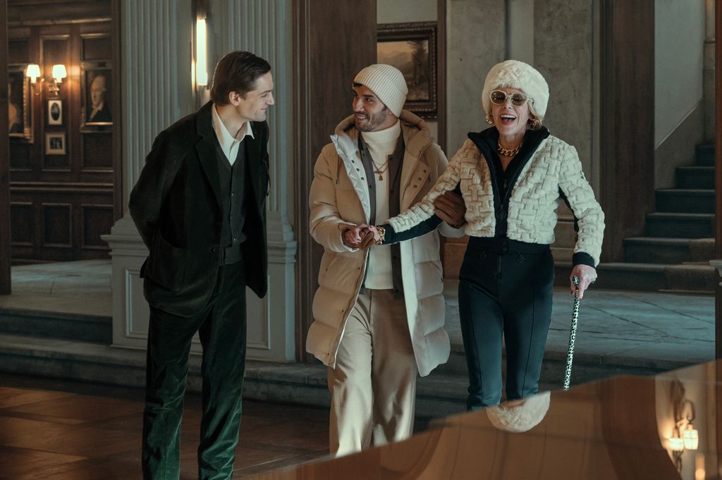 two men and woman in large hotel hall