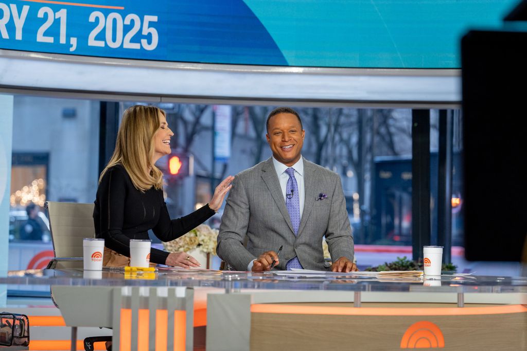 TV anchors laughing in studio 
