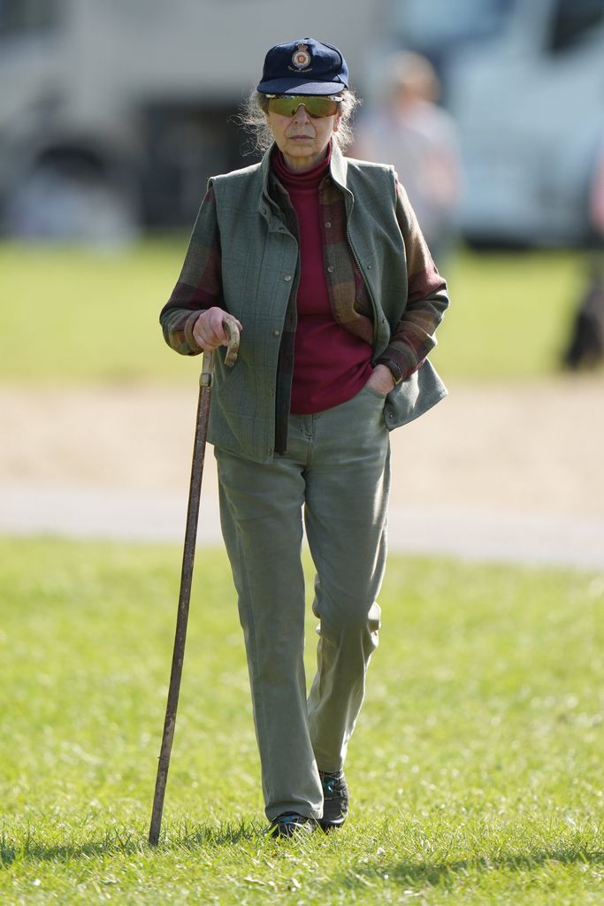 Princess Anne, wearing cap, uses shepherds crook 