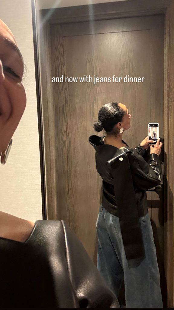 Tracee Ellis Ross takes a photo of her black leather dress styled with jeans for her Instagram Stories