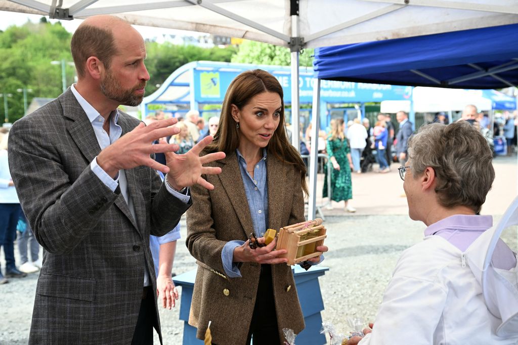 William and Kate speaking to stall holder at beekeeper's stall