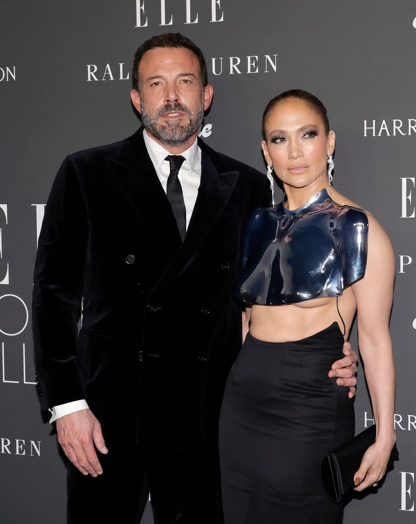 Ben Affleck and Jennifer Lopez pose together on red carpet at fashion event