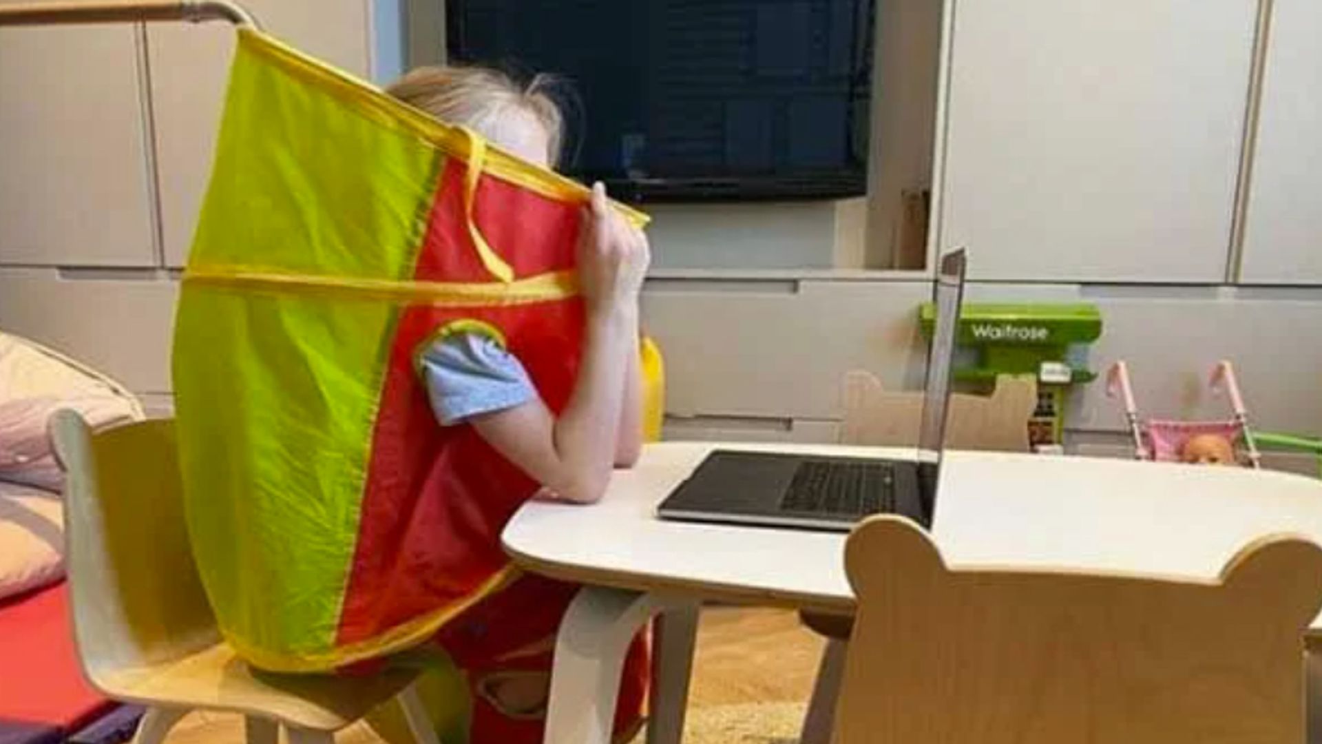 A young girl sat inside a play tunnel
