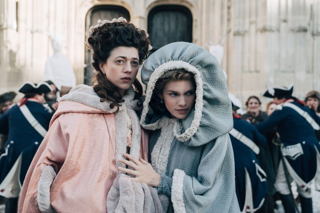two women in period clothing in street