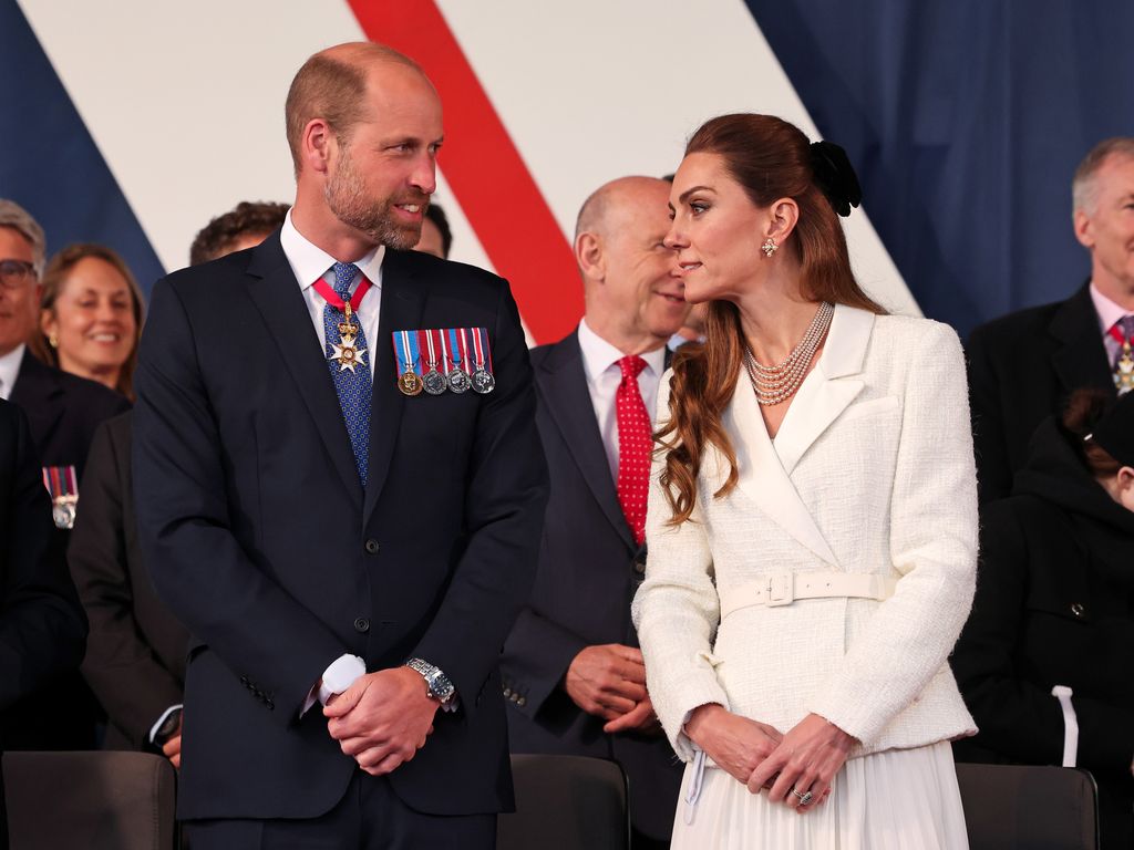 Prince William standing with Princess Kate
