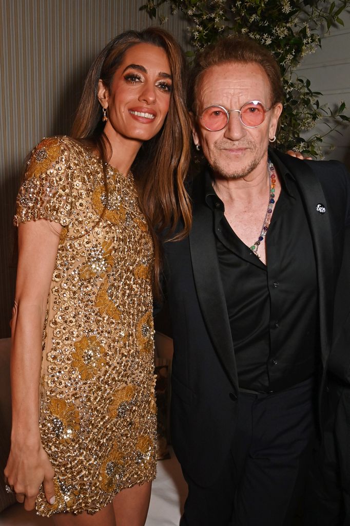 Amal Clooney and Bono celebrate Apple Original Films' "Bono: Stories of Surrender" Cannes Film Festival World Premiere at Le Panorama Rooftop on May 16, 2025 in Cannes, France. "Bono: Stories of Surrender" premieres globally on Apple TV+ on Friday, May 30, 2025. (Photo by Dave Benett/Getty Images for Apple)