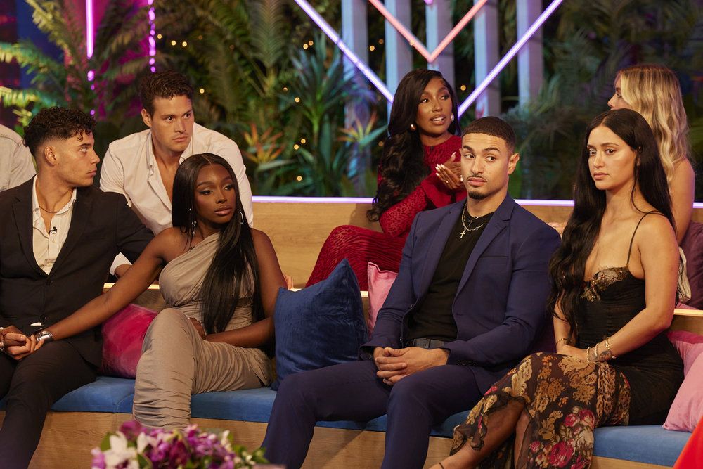 Kenny Rodriguez, Connor Newsum, JaNa Craig, Daia McGhee, Miguel Harichi, Leah Kateb, Andrea Carmona sit on a sofa during the Love Island USA reunion