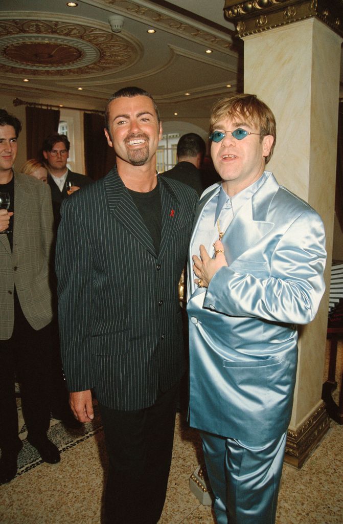 Elton John in his distinctive glasses at a party wtih George Michael in 1995 