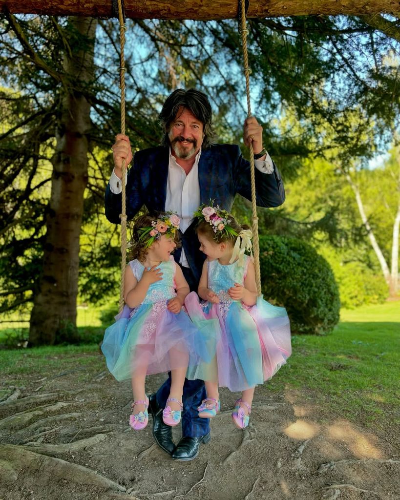 Laurence Llewelyn-Bowen with his grandkids on a swing