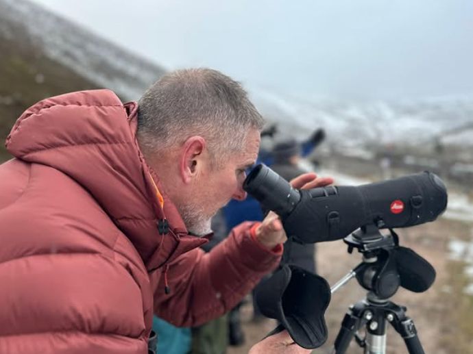Iolo Williams looking through a camera