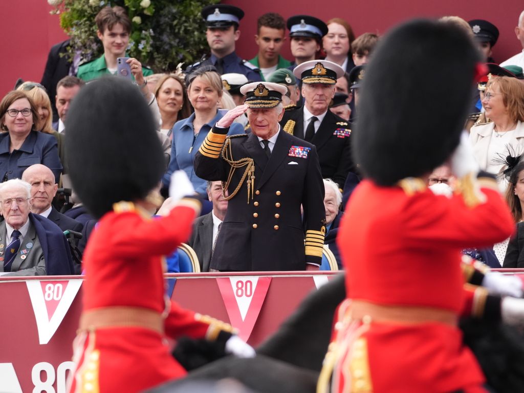 King Charles III takes the salute from the military procession for the 80th anniversary of VE Day