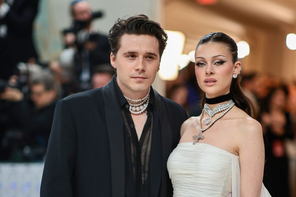 man and woman standing straight faced next to one another