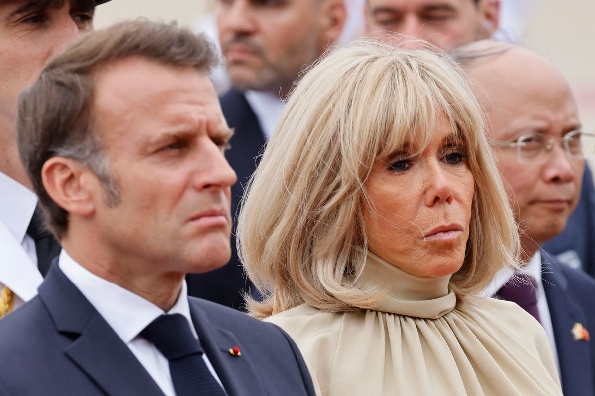 France's President Emmanuel Macron and his wife Brigitte Macron take part in a wreath-laying ceremony at the monument of national heroes and martyrs in Hanoi on May 26, 2025. 