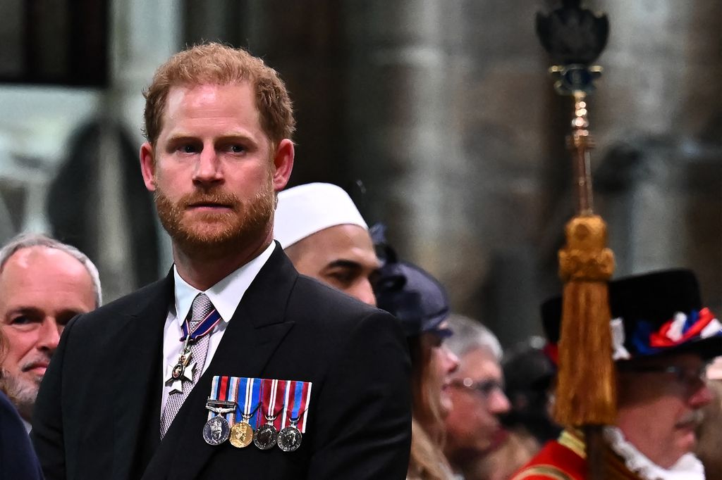 Prince Harry, Duke of Sussex looks on as Britain's King Charles III leaves Westminster Abbey after the Coronation Ceremonies in central London on May 6, 2023
