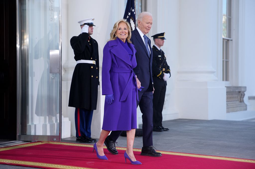 Jill Biden lit up the scene in a vibrant cobalt-blue coat and matching heels. The belted waist added a flattering, feminine touch. She wals to the Inauguration on a red carpet with Joe Biden. 
