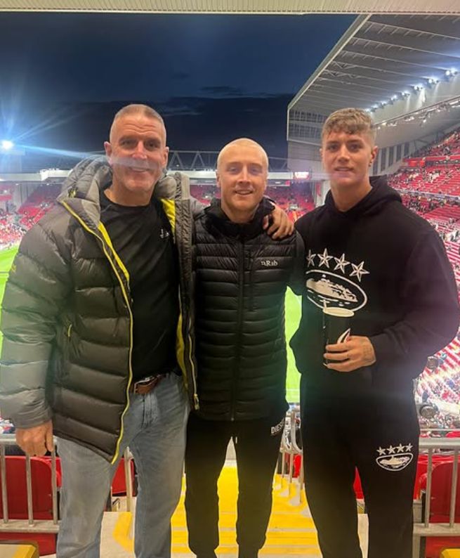 Iolo Williams and his two sons inside a football stadium