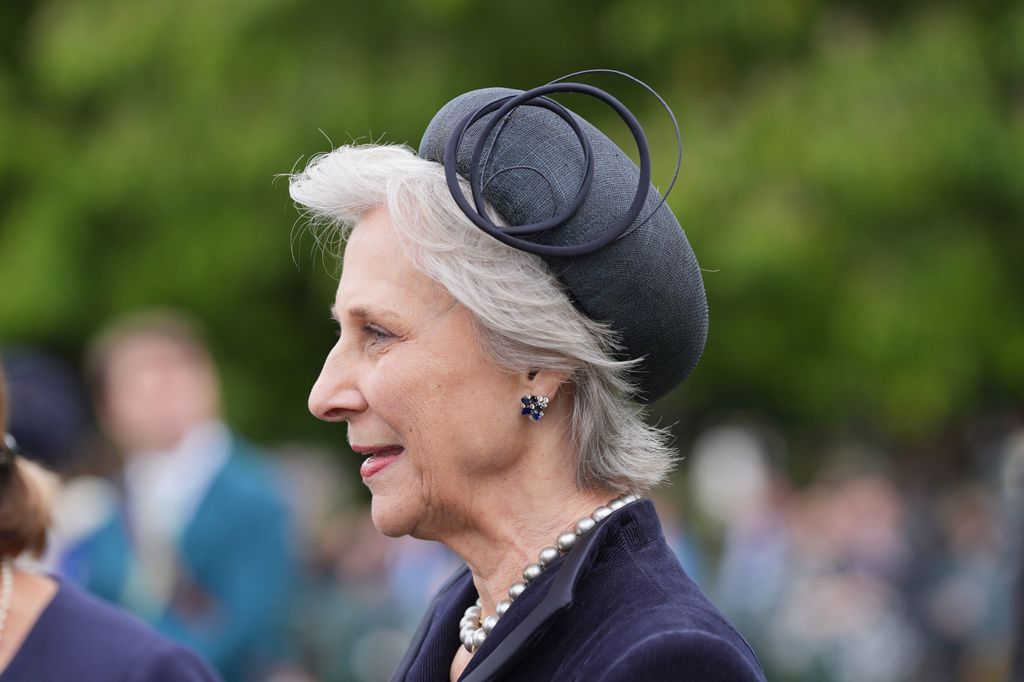 Duchess of Gloucester wearing black hat at garden party