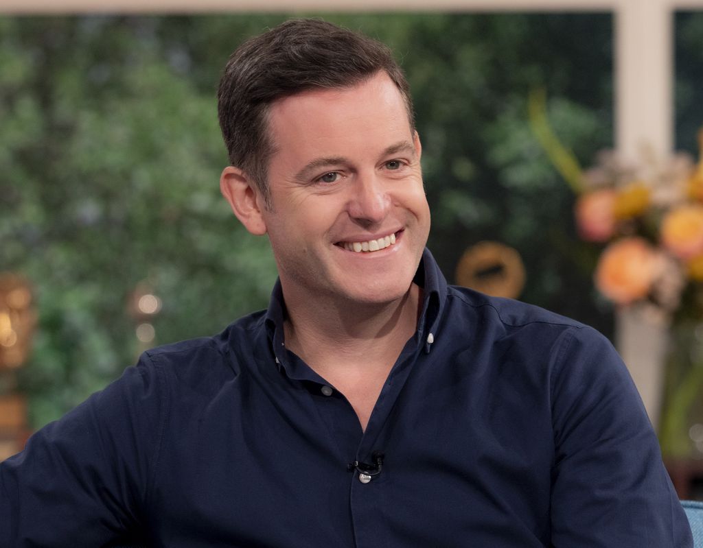 Matt Baker in a blue shirt smiling for the camera during an appearance on This Morning