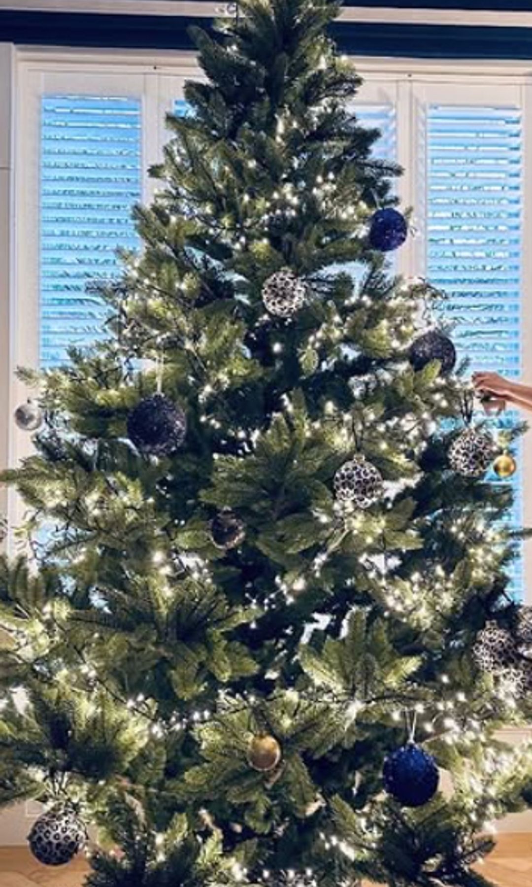 Four children decorating a Christmas tree