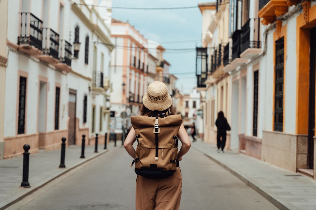 Young Asian woman with backpack finding direction while traveling. Travel and vacation. Lifestyle and technology.