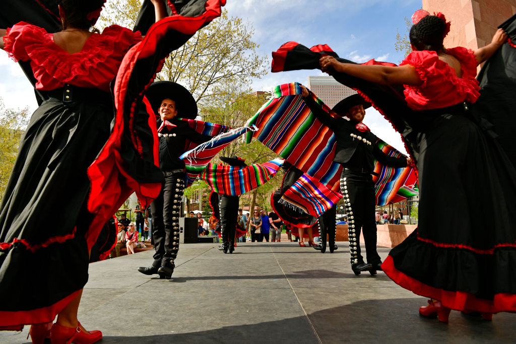 DENVER, CO - MAY 8: Dancers with Ballet Folklorico Baile Caliente perform on the Fiesta Folkloric & Confluence Music Stage during Cinco De Mayo festivities at Civic Center Park on May 8, 2022 in Denver, Colorado. The annual event is back after a two year hiatus due to the pandemic. The festivities included dancing, music, vendors, food and entertainment for children. The Cinco de Mayo "Celebrate Culture" Festival is produced by NEWSED Community Development Corporation. Through their programming they conduct economic development in poor communities and provide affordable housing opportunities to low and moderate income families and individuals. Established in 1973, NEWSED's mission is "to promote and develop economic, community programs and projects that raise the income, educational and political levels of Denver residents". (Photo by Helen H. Richardson/MediaNews Group/The Denver Post via Getty Images)
