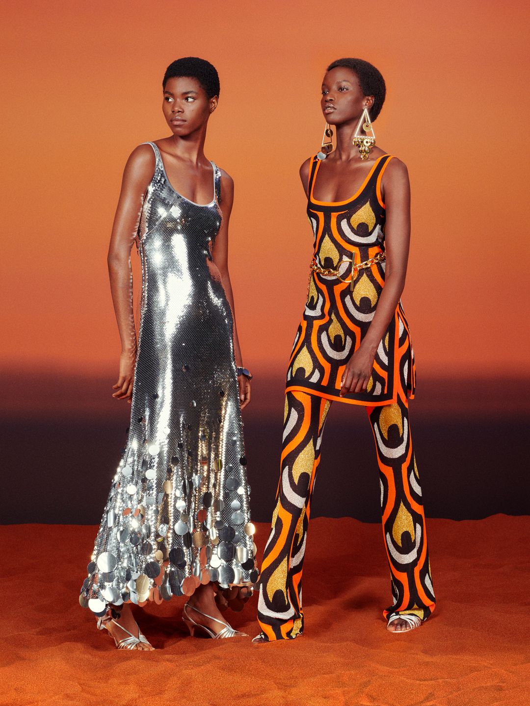 Models wearing silver disc dress and patterned glittery co-ord from H&M x Rabanne collection  