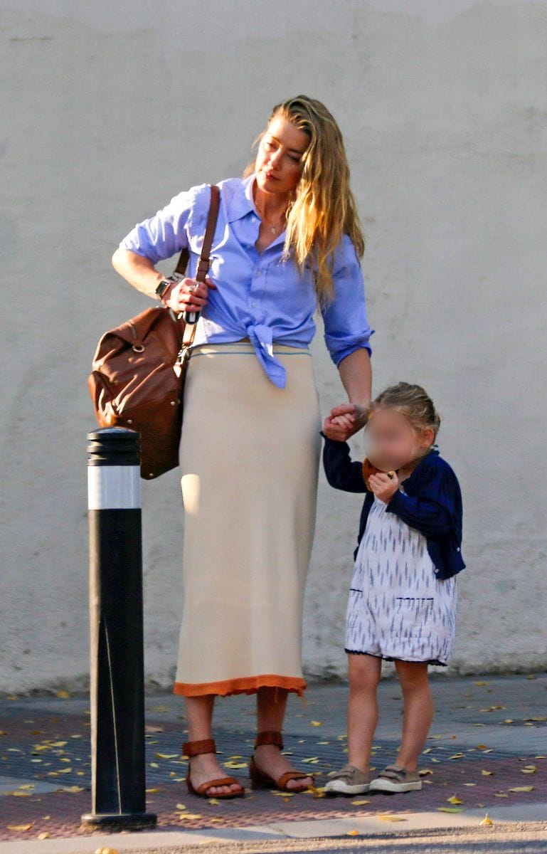 Amber Heard walks with her daughter, Oonagh Paige, on the street in Madrid