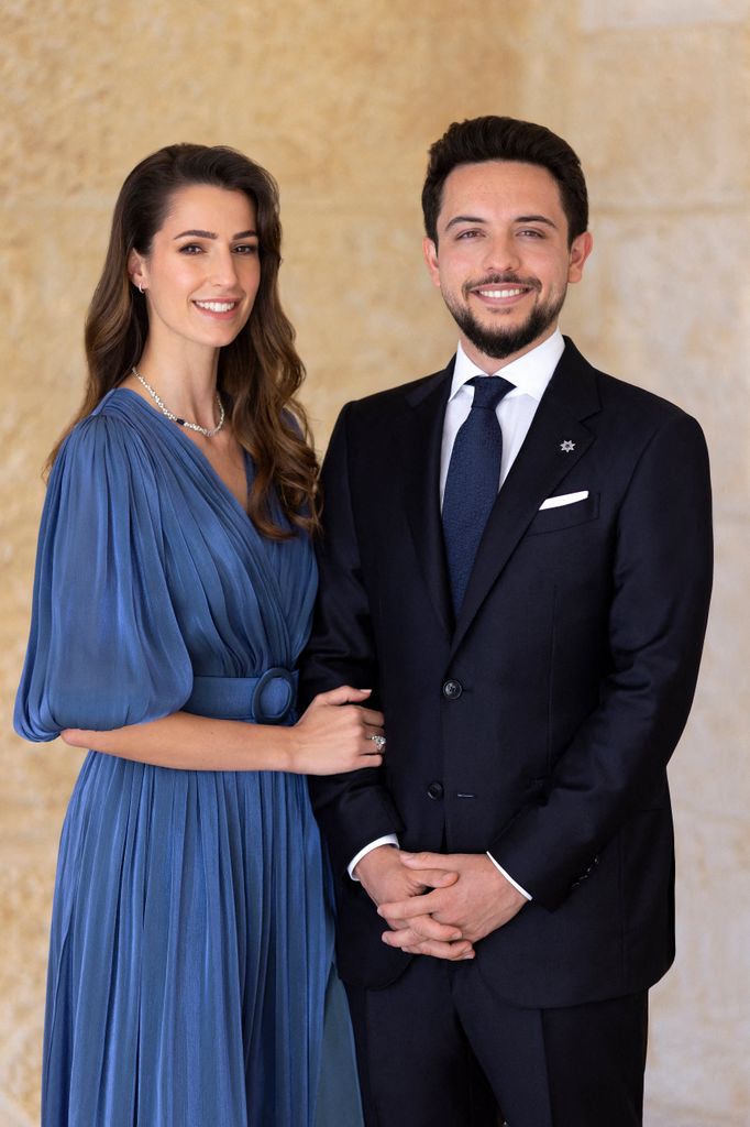 Princess Rajwa in a blue dress with Crown Prince Hussein in a black suit