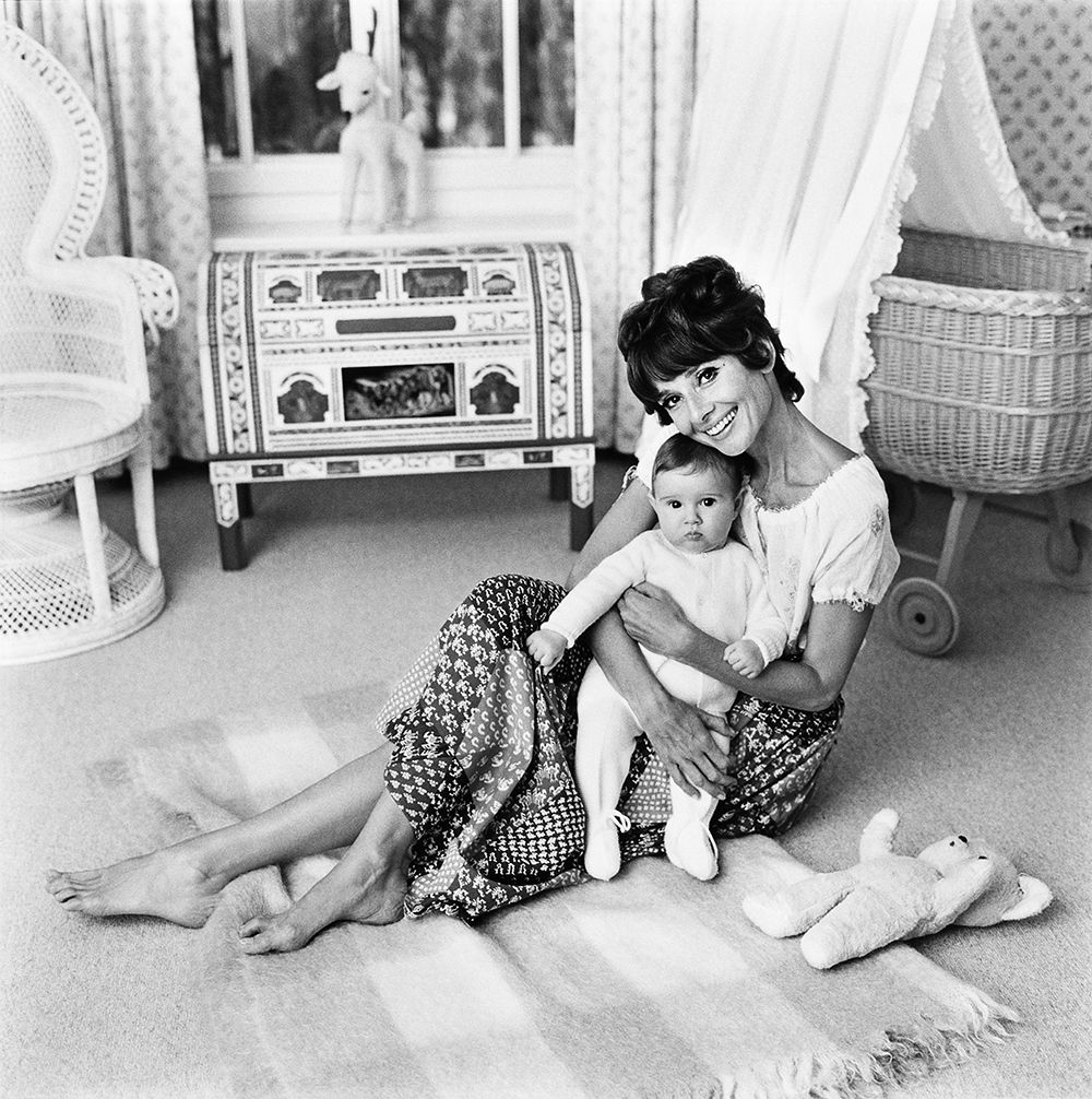 Audrey Hepburn cuddling her son Luca in the nursery at her Swiss home