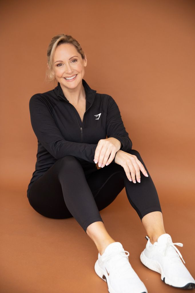 Beautiful woman sitting on the floor wearing activewear