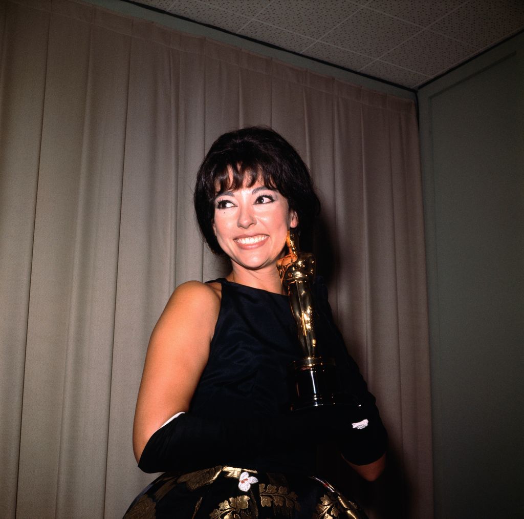 Rita Moreno is shown here smiling as she holds her Academy Award in 1962