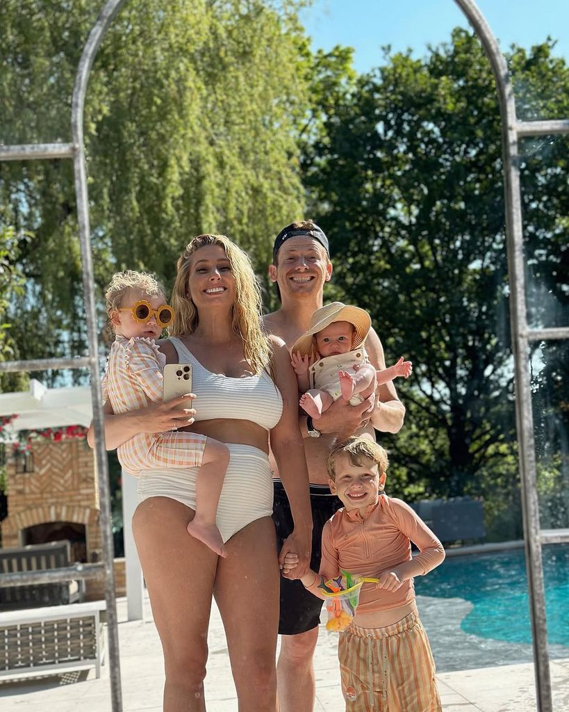 Stacey Solomon and Joe Swash with three of their children as they take a mirror selfie with pool in the background