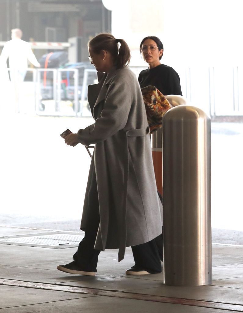 Bridget Fonda in gray coat at LAX