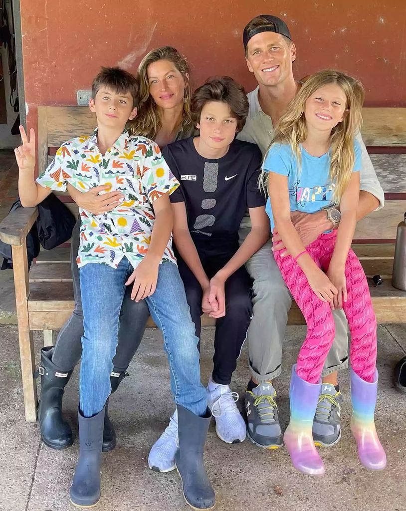 Gisele Bundchen and Tom Brady sit with Jack Brady between them, Benjamin Brady on Gisele's lap and Vivian Brady on Tom's lap