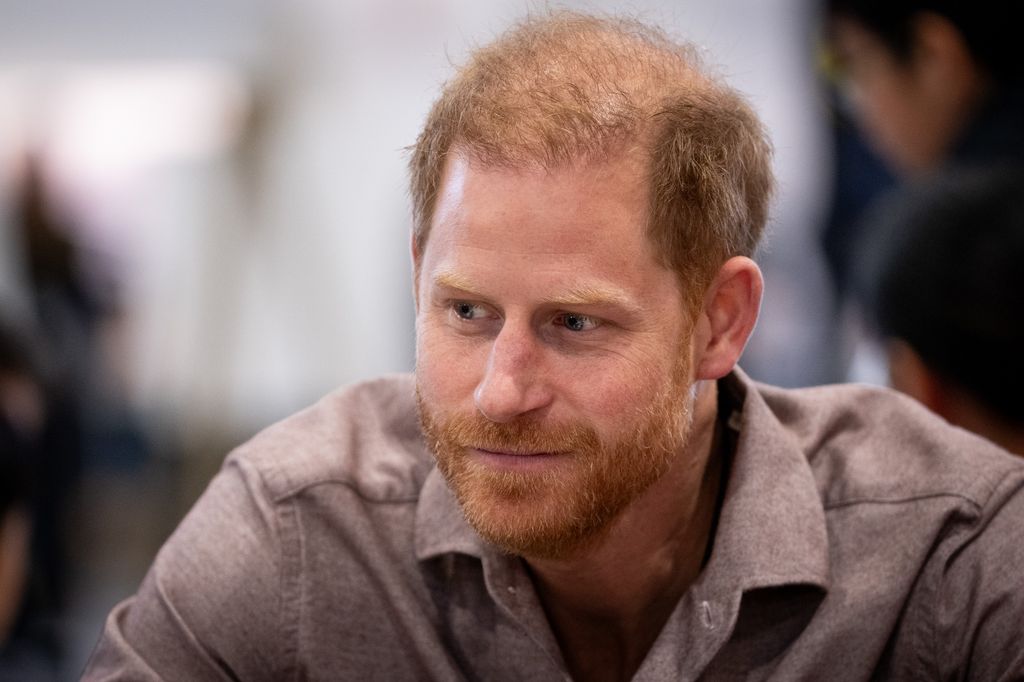 Prince Harry in a grey shirt