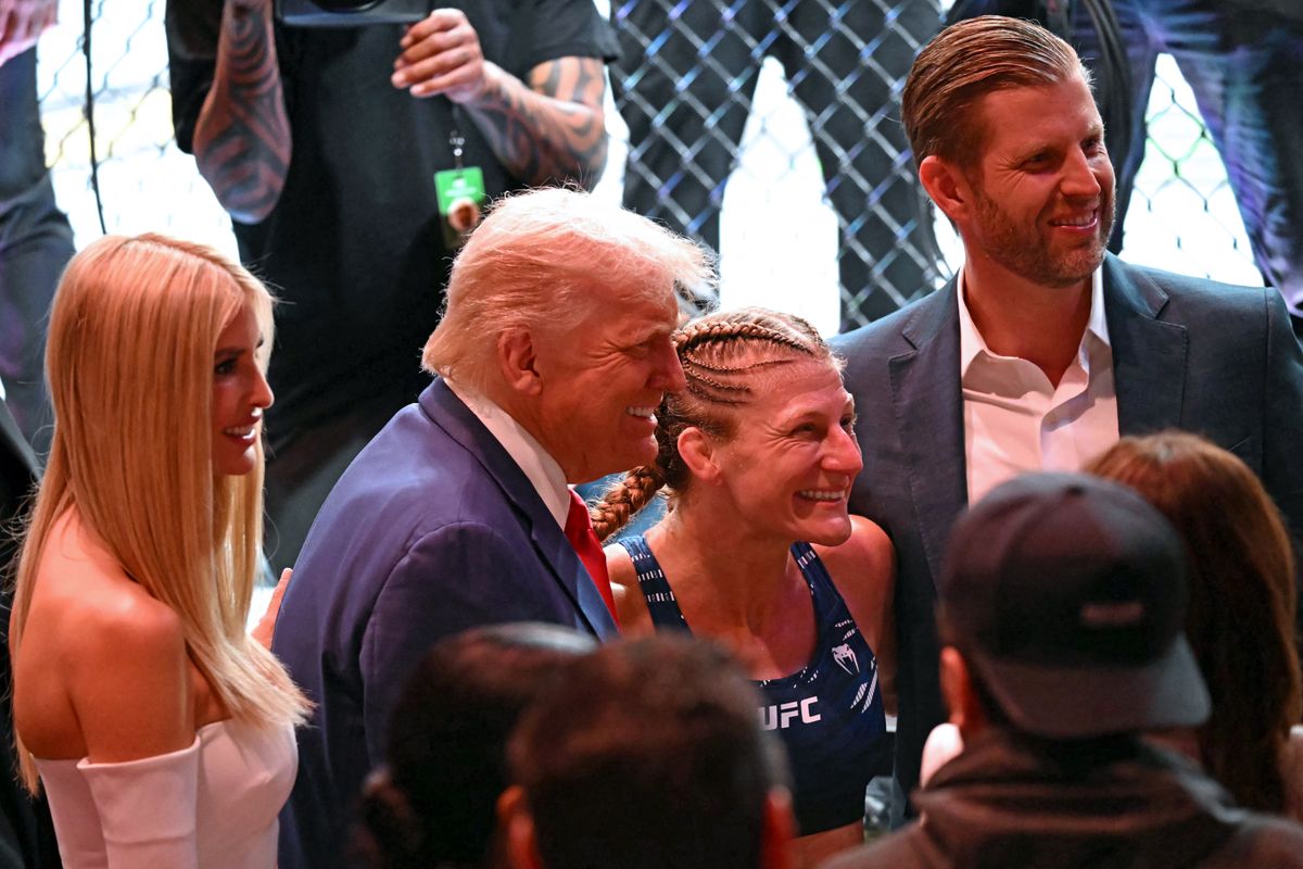 Ivanka, Donald, and Eric Trump alongside Championship winner Kayla Harrison