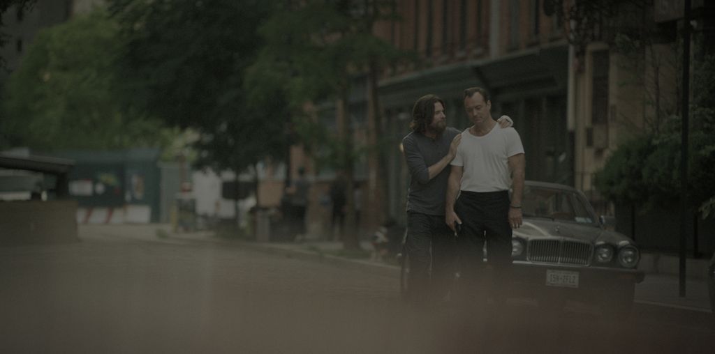 two men standing in street in city
