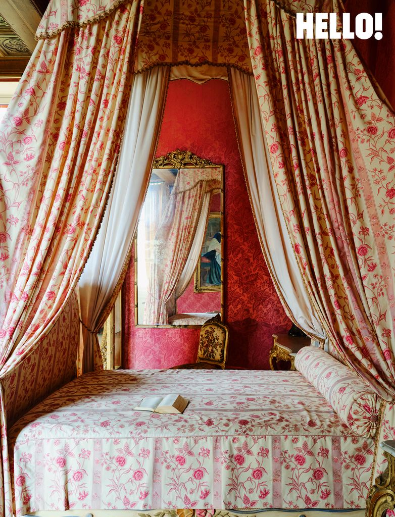 A lighter floral toned bedroom with a four-poster bed 